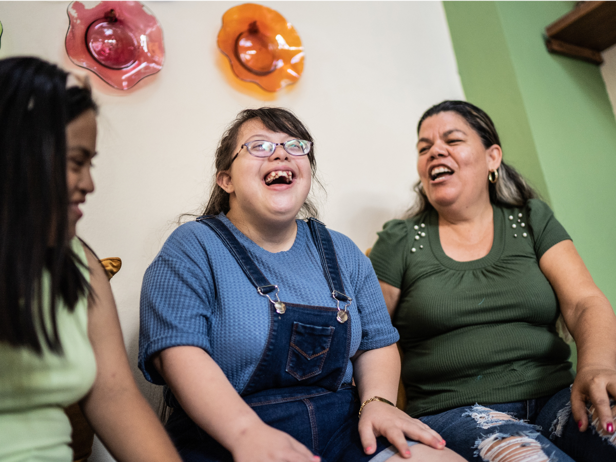 Three friends sitting down having a laugh