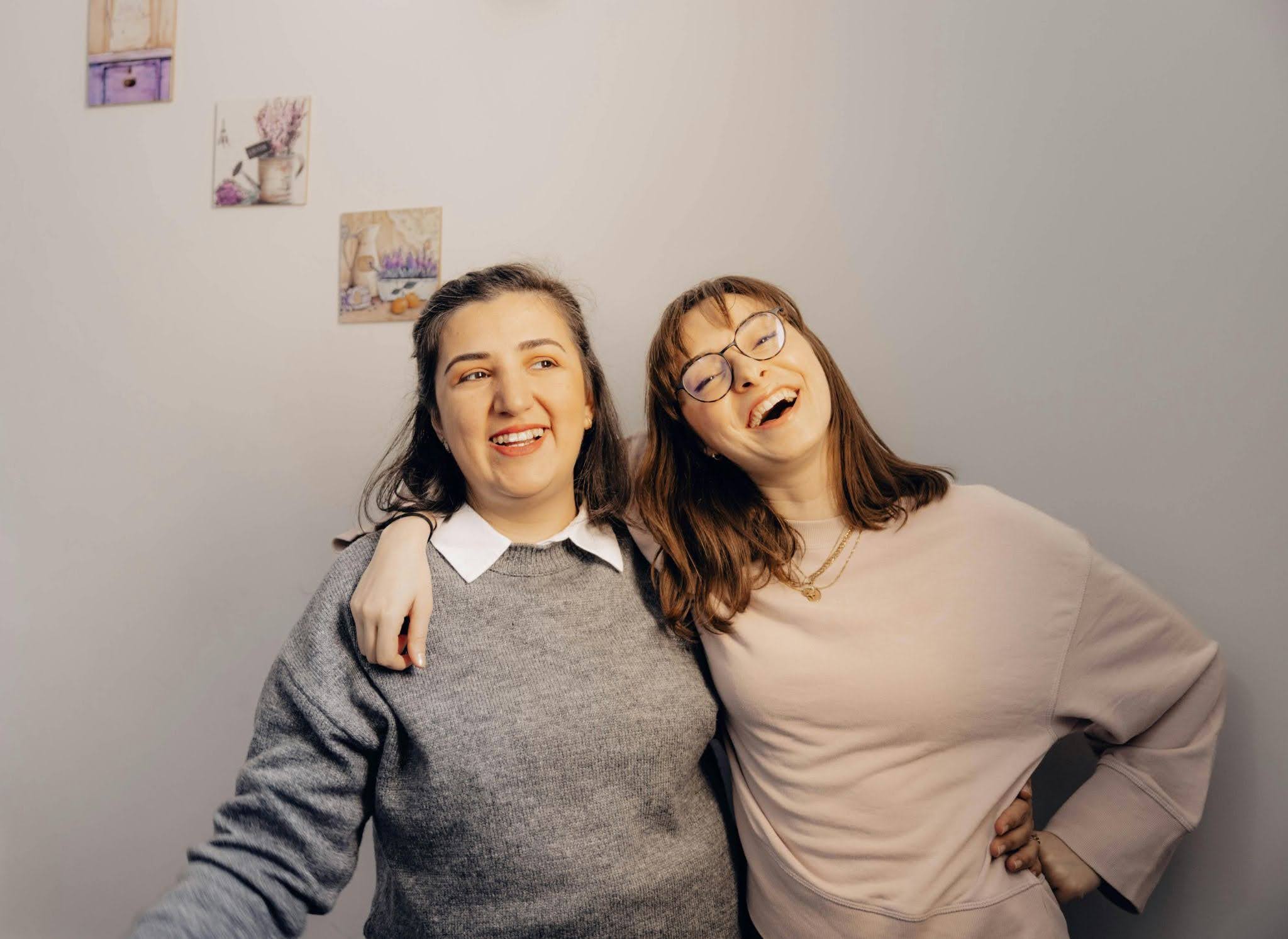 Two autistic adults who are friends embracing one another