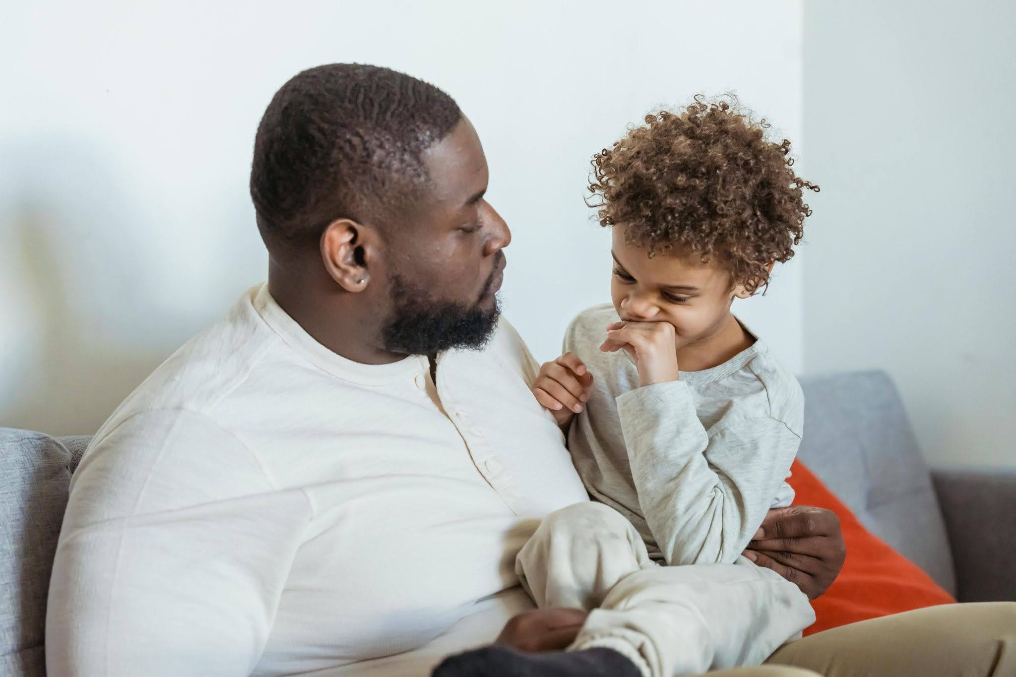 A father counsels his child on acting politely and appropriately toward others
