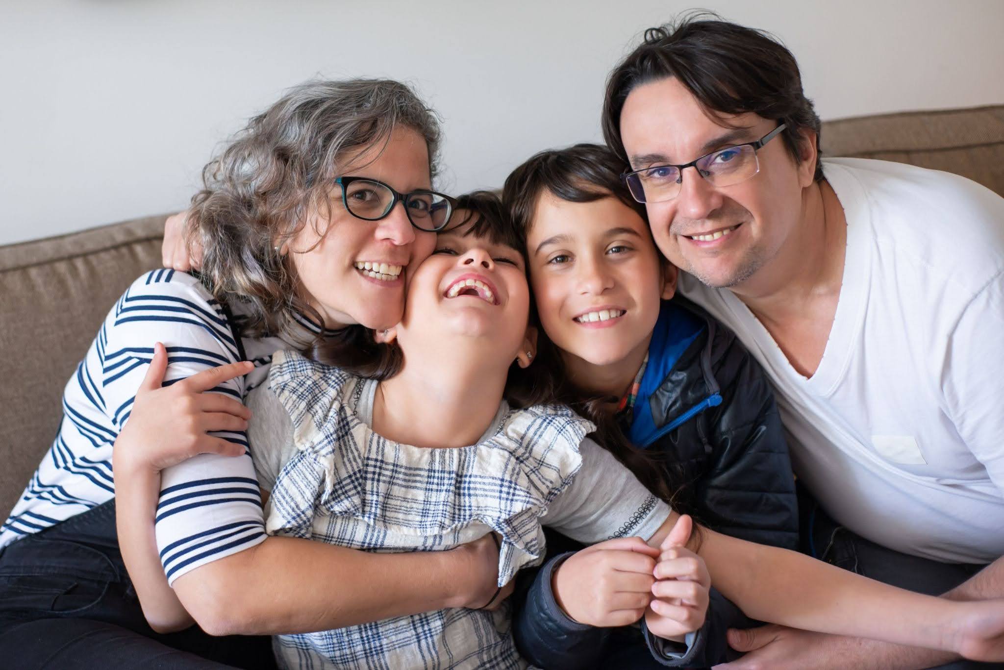 The family of an autistic child embraces one another.