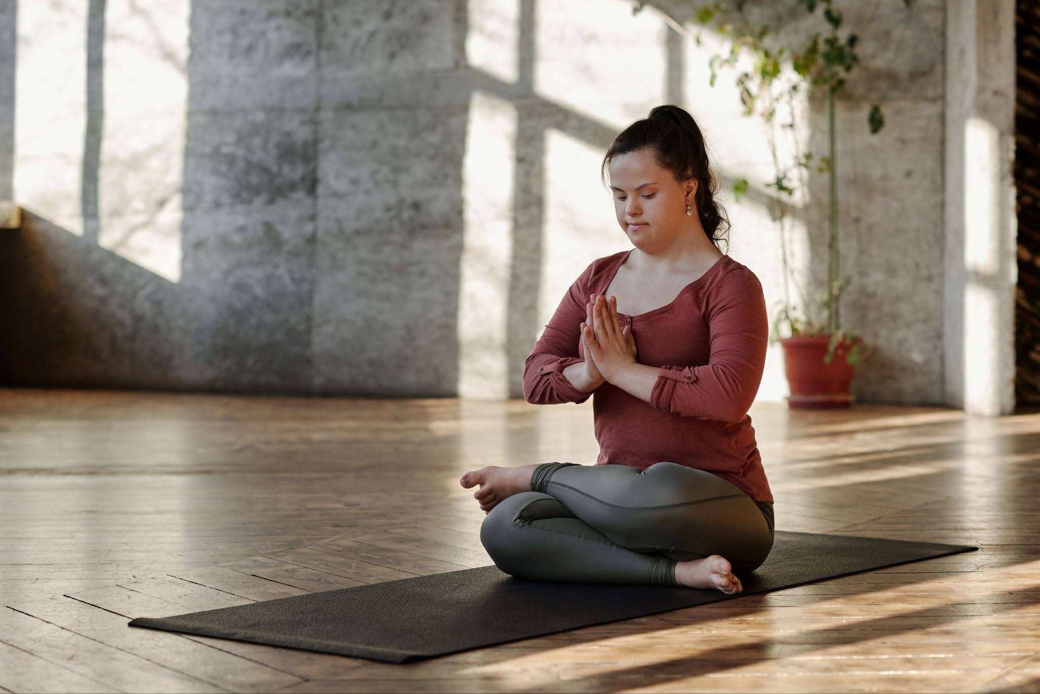 A woman with autism is practicing yoga