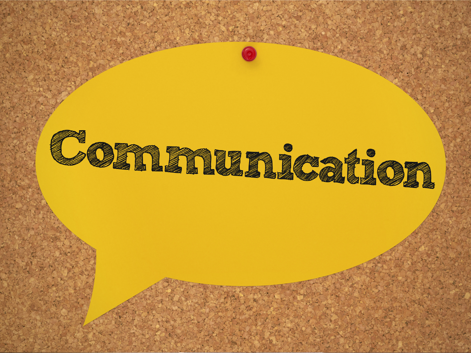 A yellow speech bubble pinned to a corkboard with the word “Communication” inside.