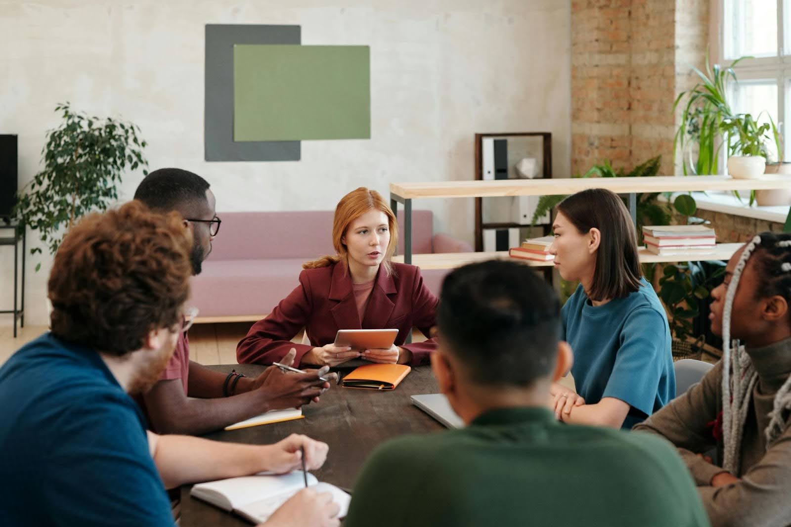 People reunited around a table listening to each other on Person-Centered Planning