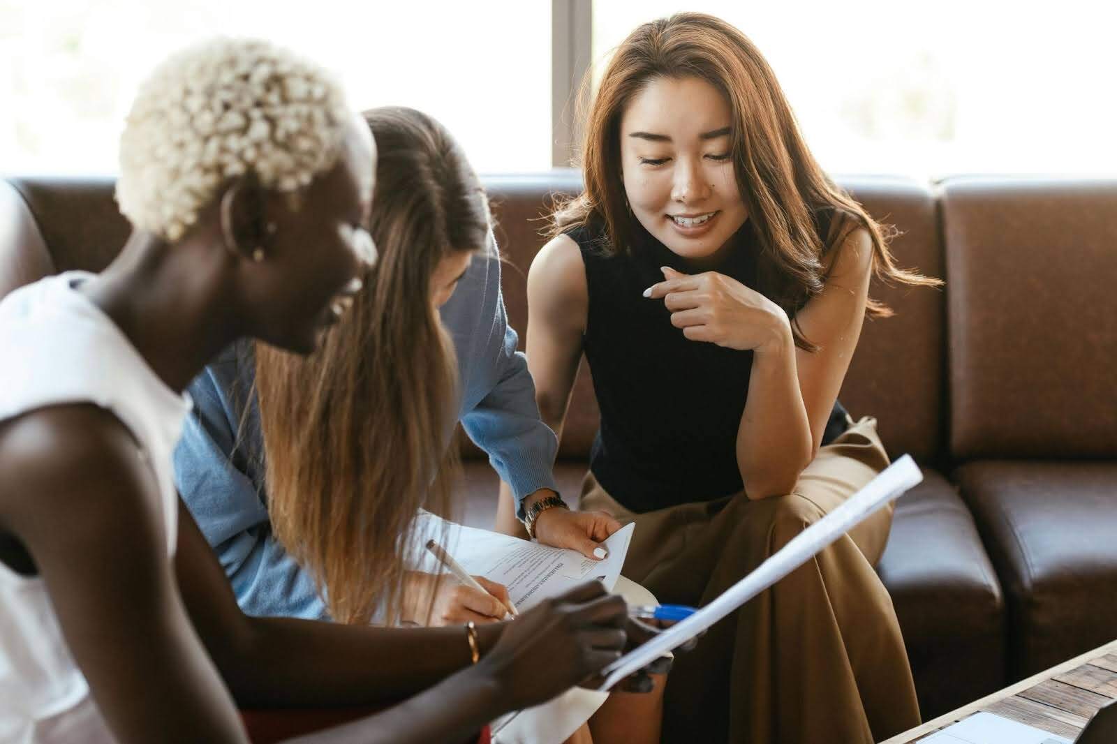 Three people looking over a paper