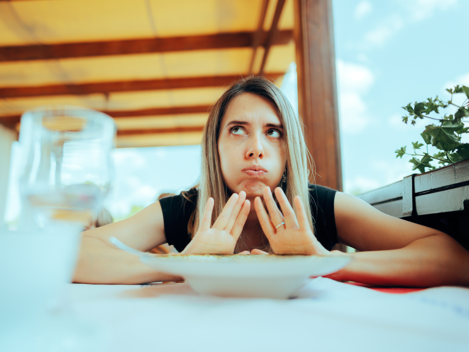 An adult with food aversions pushing away a bowl