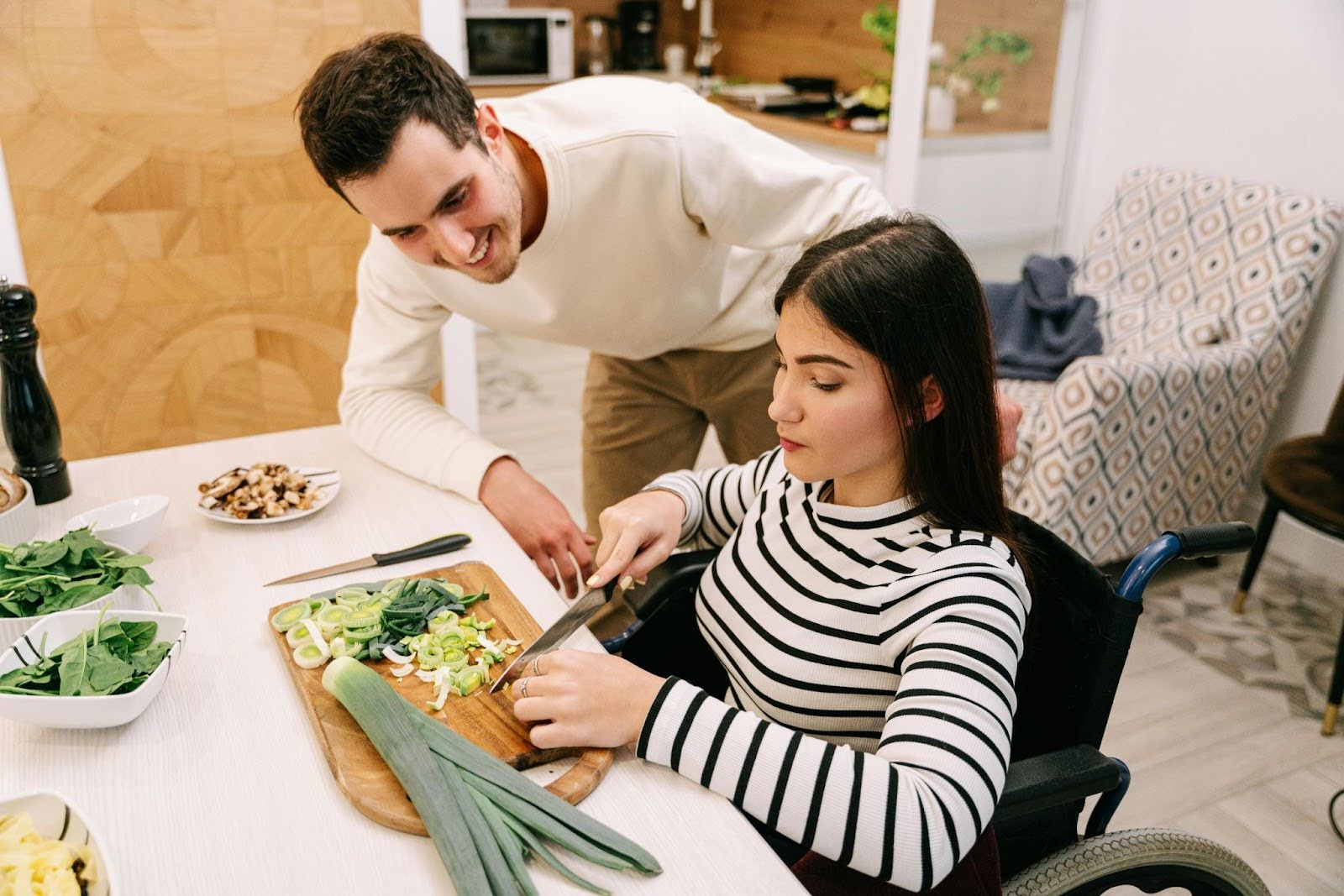 Women in wheelchair using a cutting board