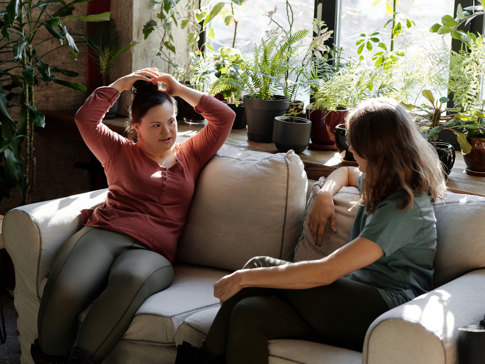 Two speak to each other on a couch