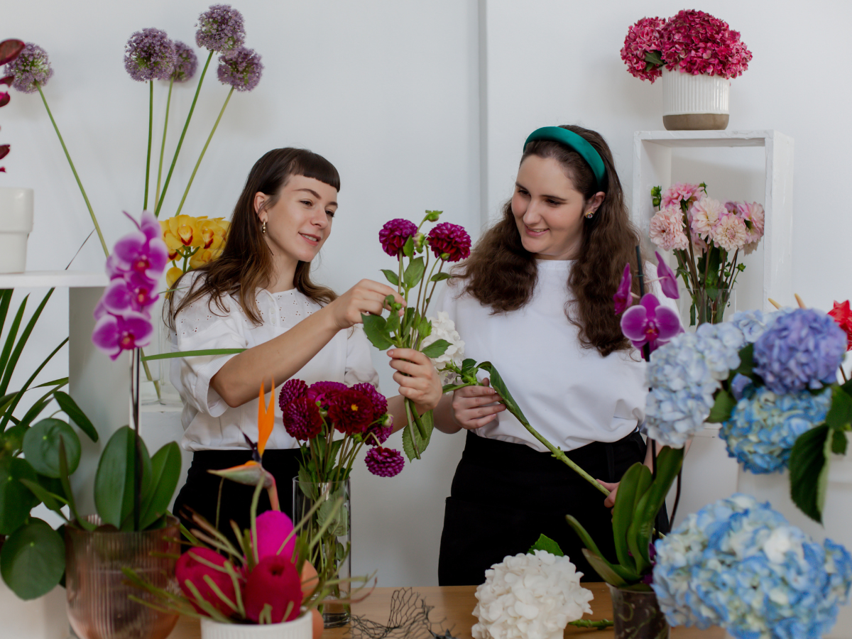 Two women pick out flowers together