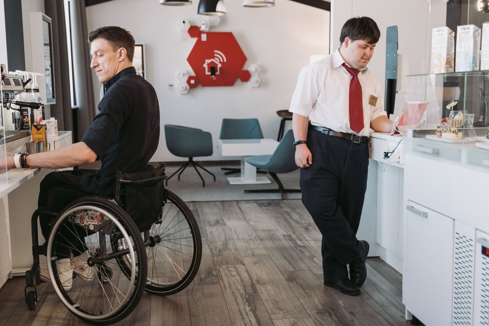 Two men in an office, one in a wheelchair