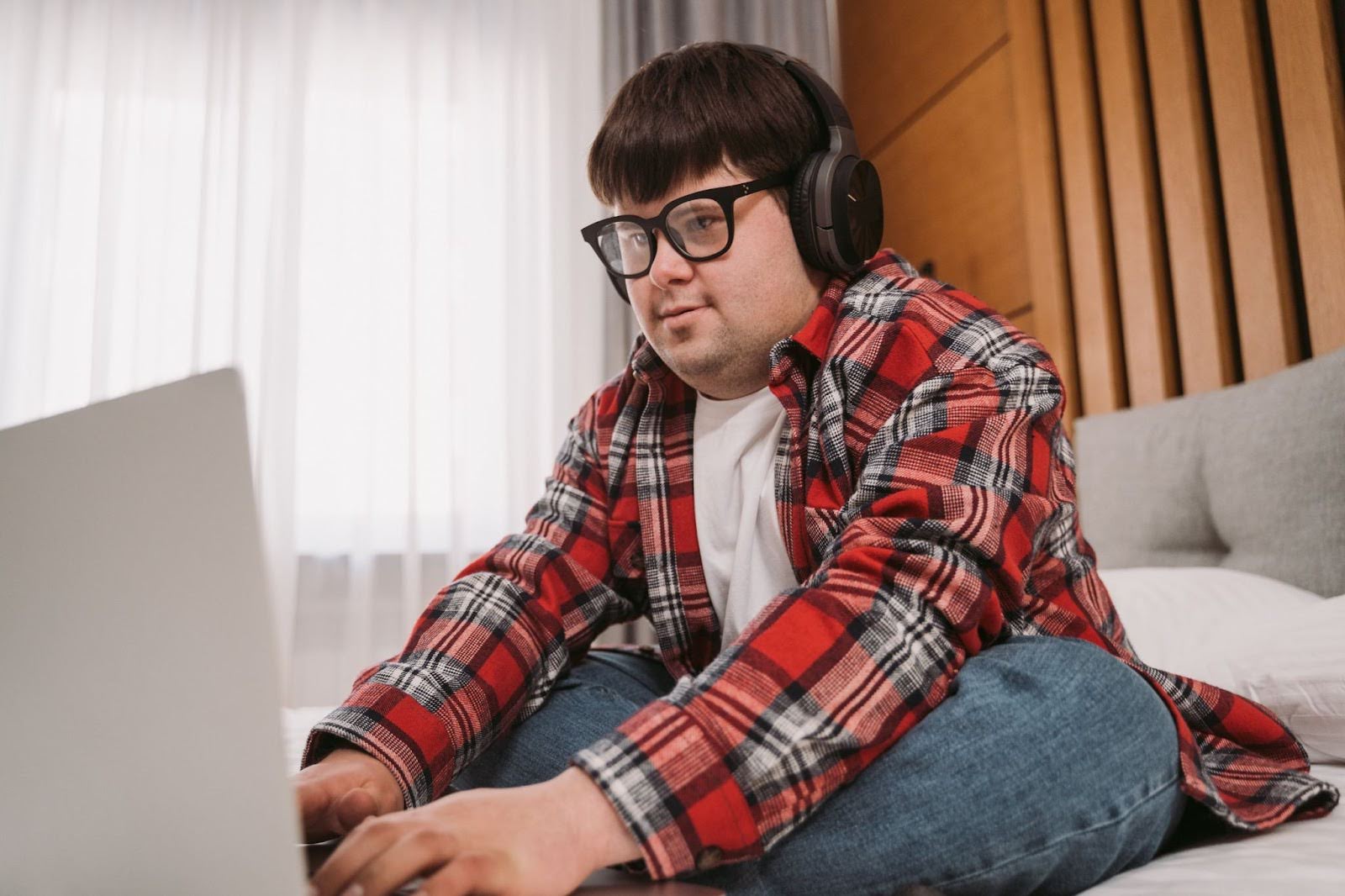 A man with down syndrome works on a laptop
