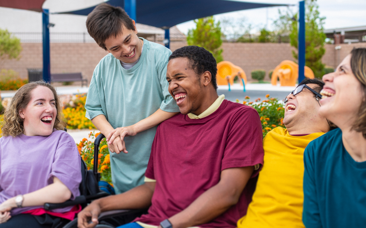 Five Self-Determination Program Participants laugh together