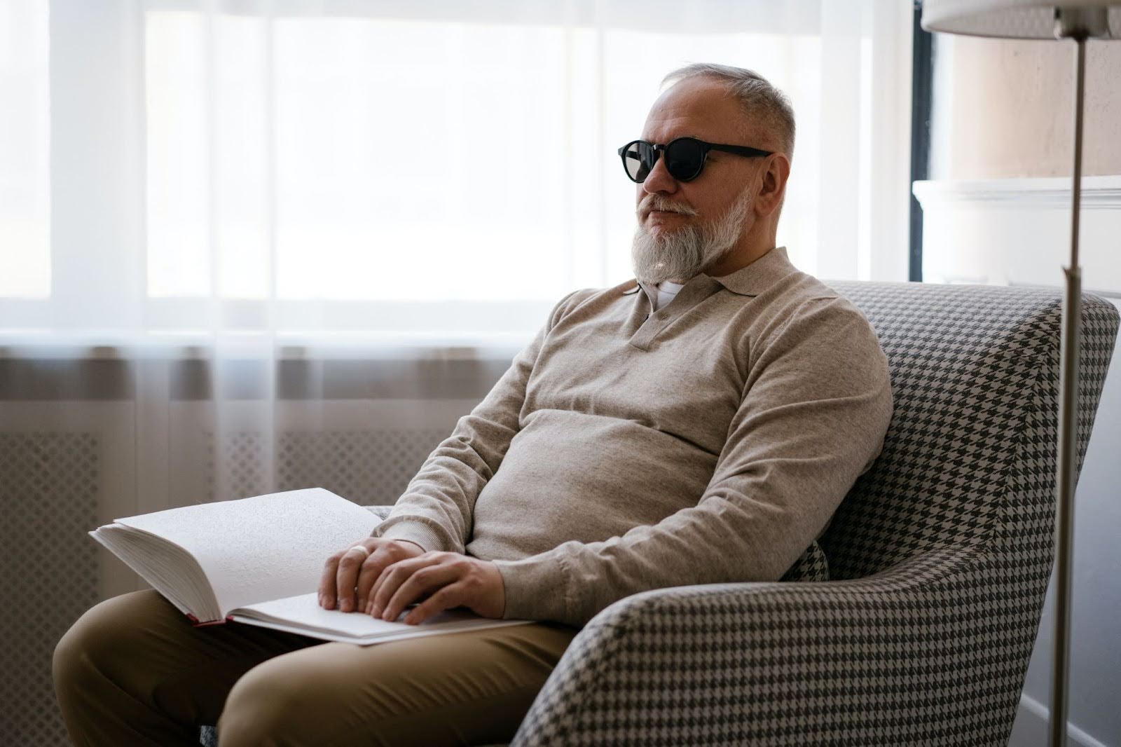 A blind man reads braille. 