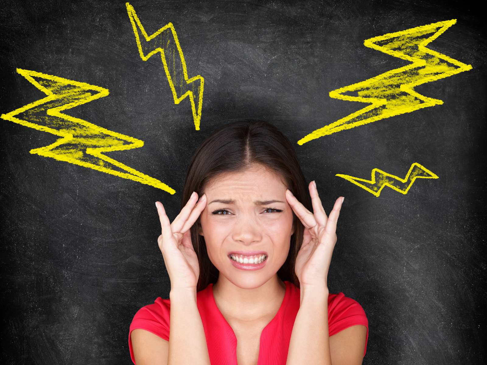 Person grimacing and touching their face with hand-drawn lightning bolts pointing toward their head 